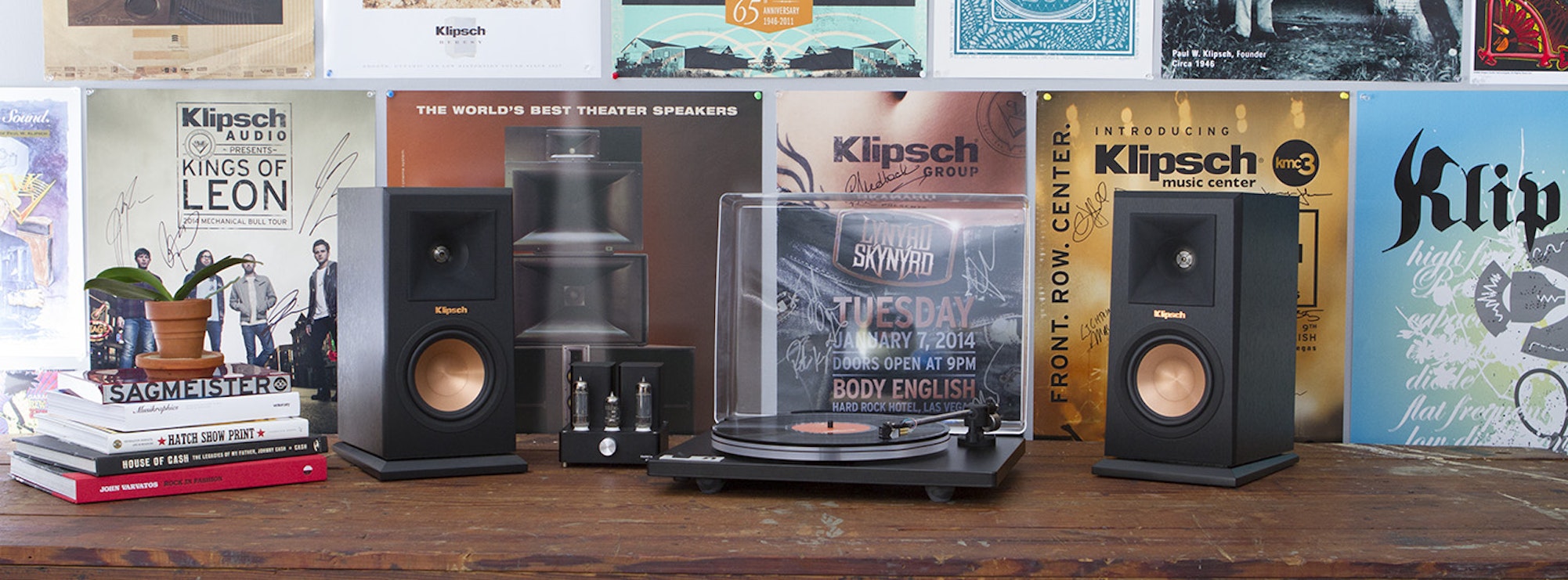 U-Turn turnable with two R-15PM powered speakers in front of Klipsch plaques